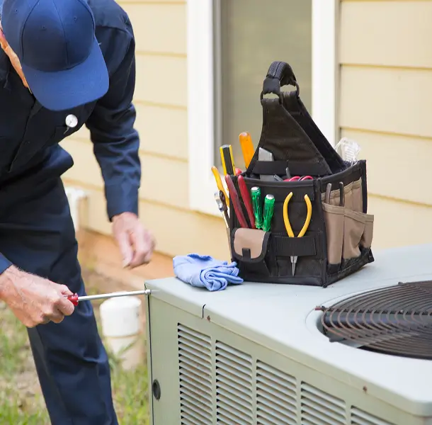 Technician repairing an air conditioning unit.