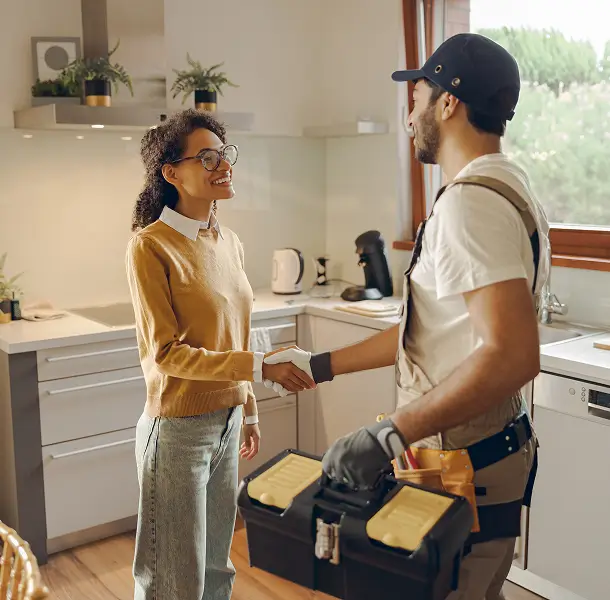 Person shaking hands in a kitchen.